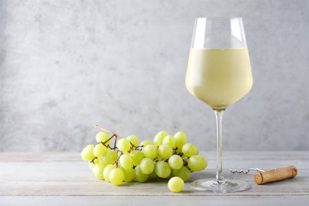 istock Misted glass of cold white wine on gray background 1257732975