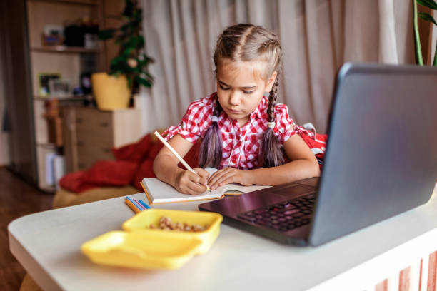 istock Distant education, back to school. Girl studying homework during online lesson at home 1257733247