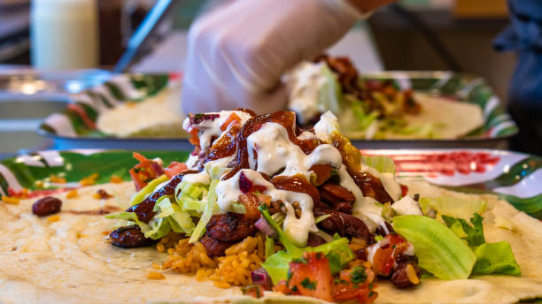 istock Mexican traditional authentic homemade Burrito with pulled pork beef chili con carne served with tomato salad and avocado guacamole and dip sauce 1257733480