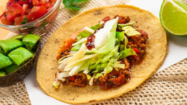 istock Mexican traditional authentic homemade tacos with pulled pork beef chili con carne serve with tomato salad and avocado guacamole and dip sauce 1257734413