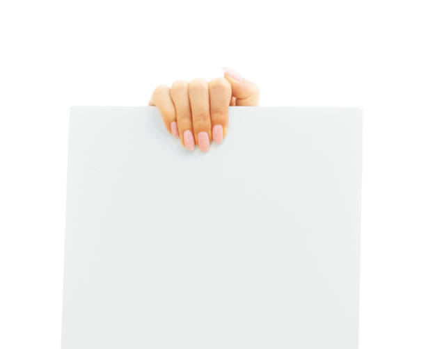 istock Blank white poster in a female hand for copy-space. 1257735546