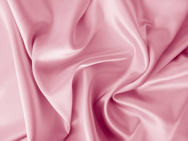 istock Beautiful elegant wavy light pink satin silk. 1257737830