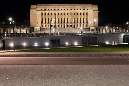 Helsinki / Finland - April 26, 2020: Finnish parliament building illuminated during night time.