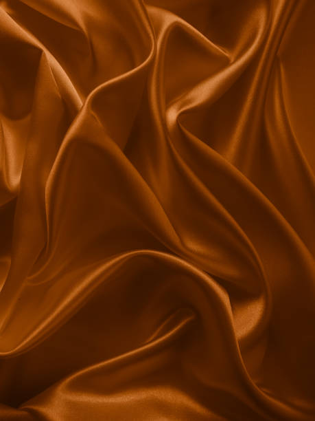 istock Beautiful elegant wavy brown satin silk. 1257737880