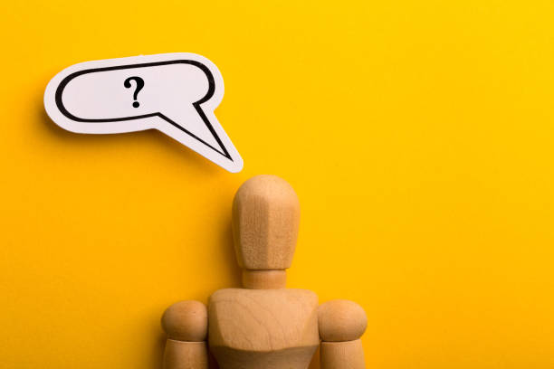 istock Wooden Man With Question Mark Speech Bubble 1257739474