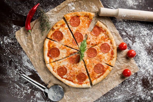 istock Pizza Pepperoni. Delicious pizza with ingredients and spices on table 1257741607