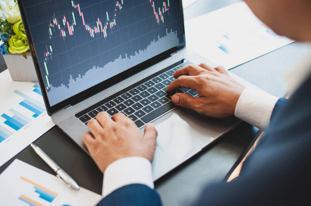 istock Business people work with laptops while analyzing stock investments by graphs. 1257744379
