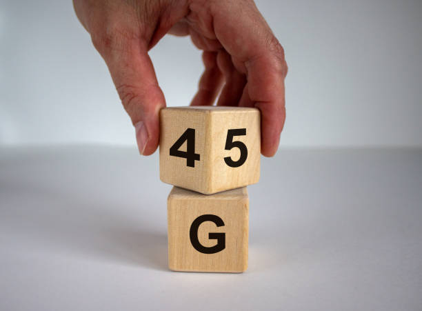 istock Man hand flips cube with numbers 4 and 5. 4 or 5 G technology concept. Beautiful white background, copy space. 1257745248