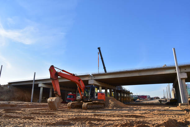 istock Excavator working at construction highway ramps and bridgeworks. 1257747118