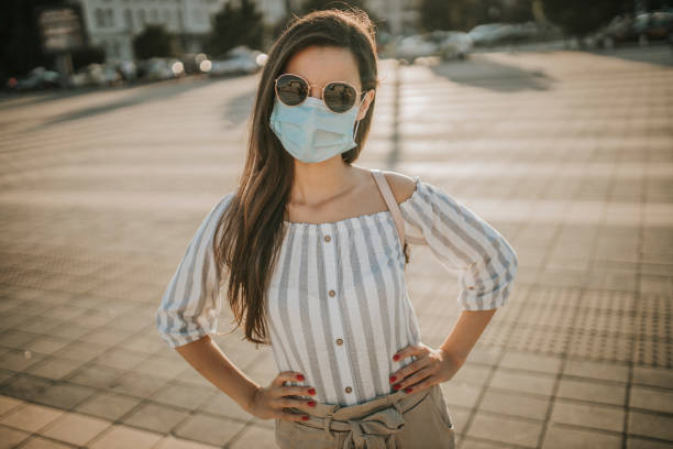 istock Woman wearing a surgical mask on empty plaza during the lockdown 1257749043