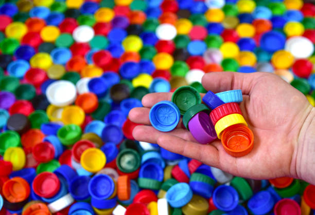 istock Plastic bottle caps background. Waste cap material is recyclable. Plastic lids from HDPE for recycle. Recycling plastic bottle caps. 1257752438