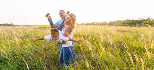 istock Happy family playing in a wheat field. 1257752500