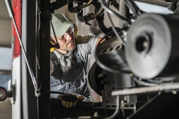 Photo of Automotive Mechanic Performing Scheduled Diesel Engine Service