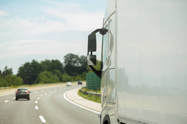 modern semi truck on a highway right before strong curve - turning right imagens e fotografias de stock