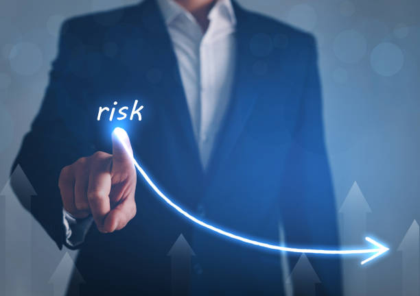 istock Businessman draw descending curve in graph to reduce corporate risk. 1257753949
