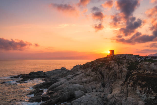 istock Sun rising behind genoese tower in Corsica 1257754916