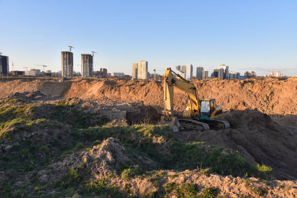 istock Excavator working at construction site on earthworks. Backhoe digging building foundation 1257755119