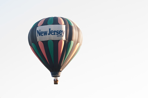 Branchburg, New Jersey - July 28, 2018: A hot air balloon with the New Jersey Monthly Magazine logo can be seen along Readington Road after launching at the Quick Chek Festival of Ballooning.