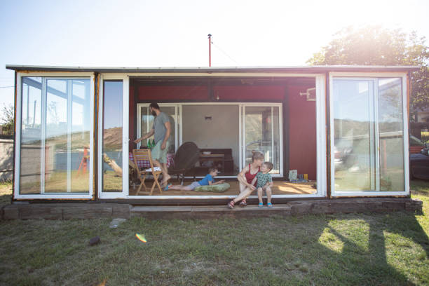 Alternative home Family with two children and a dog enjoying in their container house. prefabricated building stock pictures, royalty-free photos & images