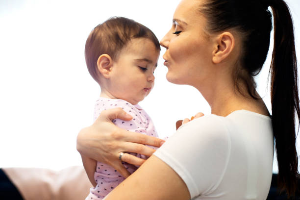 istock Mother holding her cute baby 1257759793