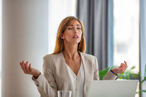 istock Woman in office meditating. 1257760018