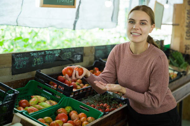 istock Woman choosing tomatoes among different varieties 1257761530