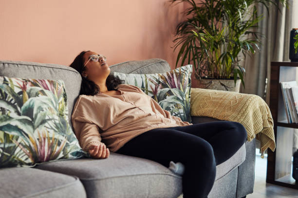 Lockdown getting you down? Shot of a young woman resting on the sofa at home boredom stock pictures, royalty-free photos & images