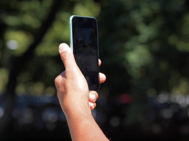 istock Hands of a mixed race man using smartphone outside 1257761670
