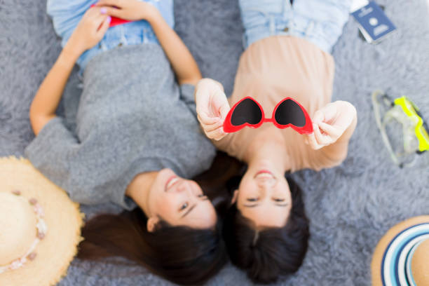istock Two Asian women planning a summer vacation trip. 1257761763