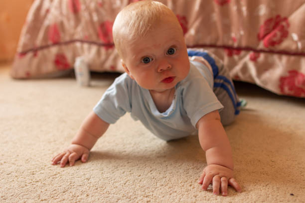istock baby boy on the floor 1257761789