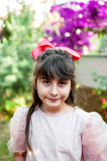 istock Turkish cute little girl posing by garden 1257762049