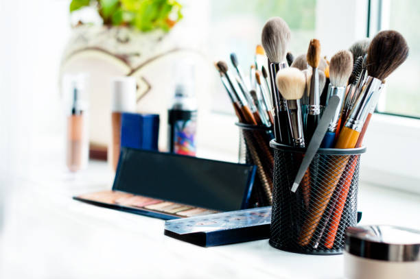 istock Makeup artist toolbox and eyeshadow palette with mirror on windowsill 1257764664