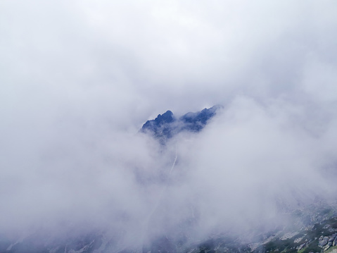 Stone mountain rock shrouded in fog