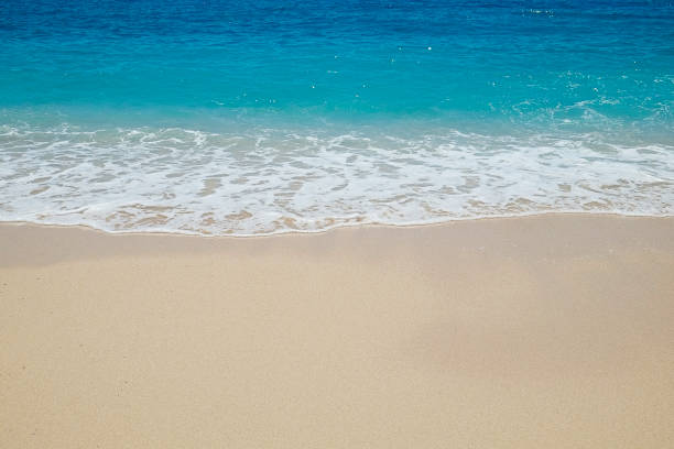 istock Sea shore with clear water waves 1257765291
