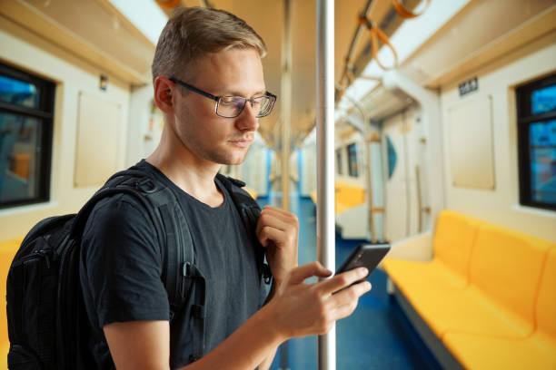 istock A man in an empty subway car is typing something on his phone 1257769823