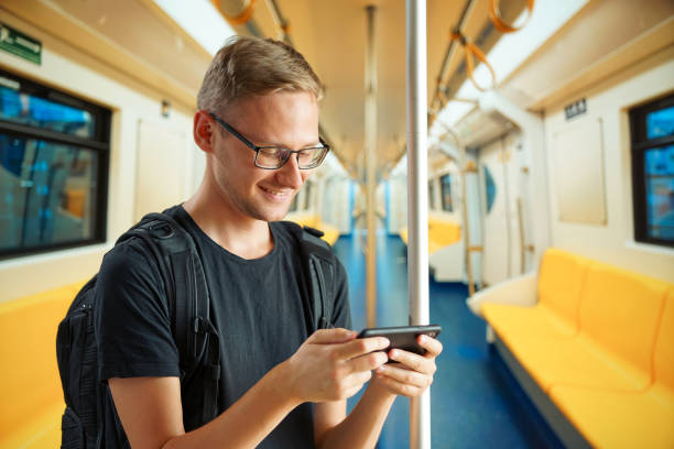 istock A man in an empty subway car is typing something on his phone 1257769847