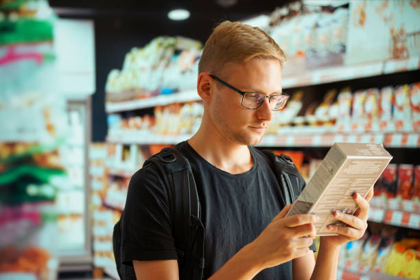 istock A man in a store compares products in different packages 1257770053