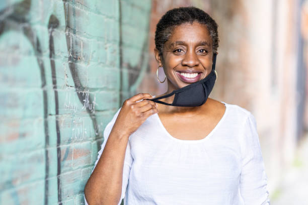 istock African American woman wearing a protective face mask 1257770095