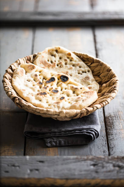 istock Vegan friendly charred flatbread in woven grass bowl 1257771210