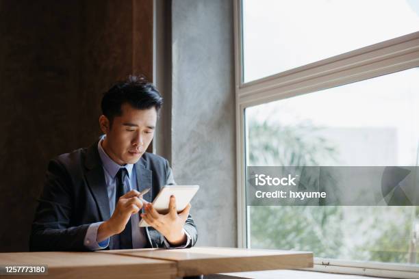 Young Asian Businessman Working With Digital Tablet And Stylus Pen Stock Photo - Download Image Now