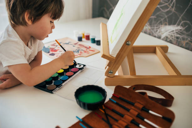 istock Little Boy Painting 1257773269