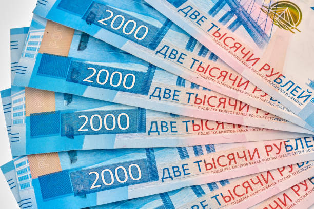 istock Stack of cash in paper russian banknotes by 2000 rubles. Isolated on white background. 1257775965