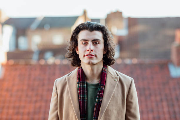 A portrait of a handsome male in his twenties looking into camera dressed in winter clothing before heading to the Xmas market in Newcastle in the North-East of England.