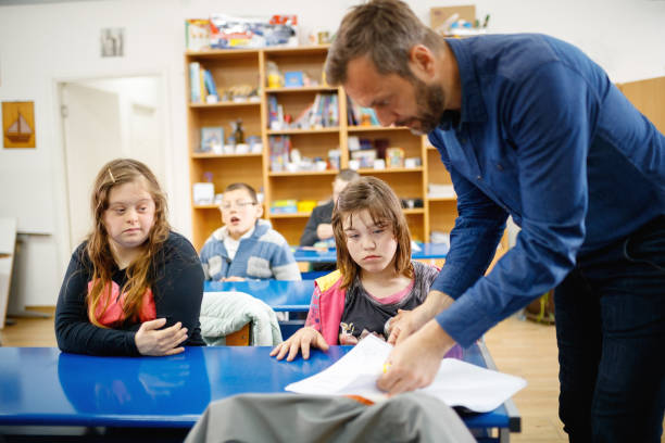 istock Teacher with a group of elementary school special needs children 1257778613
