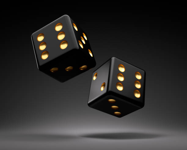 Rolling Gambling Dice Two  rolling black gambling dice on dark gray background dice photos stock pictures, royalty-free photos & images