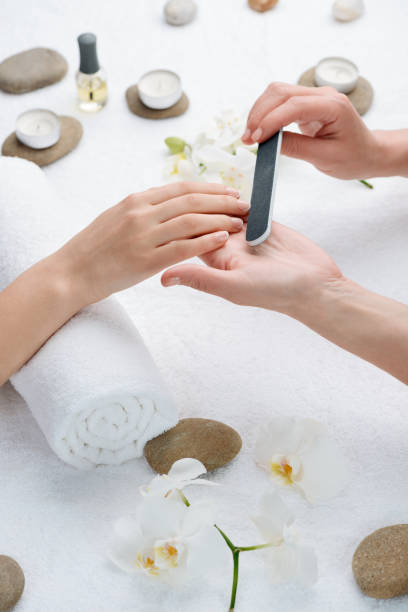 istock Woman shaping nail edges with a file tool 1257780166