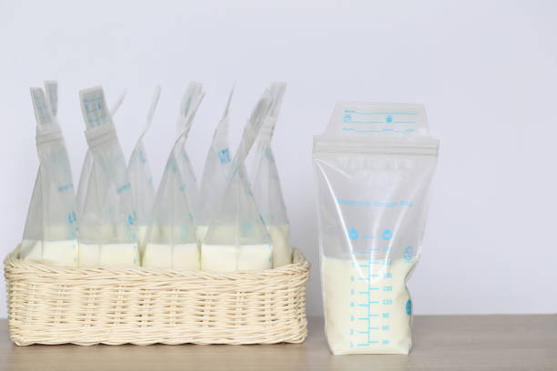 frozen breast milk storage bags for new baby on wooden table frozen breast milk storage bags for new baby on wooden table breast milk stock pictures, royalty-free photos & images