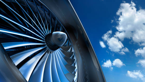 Aircraft jet engine turbine Close-up of aircraft jet engine turbine against a blue sky with white clouds aerospace industry stock pictures, royalty-free photos & images