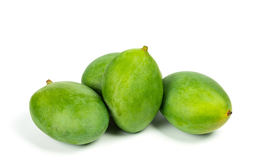 Green mangos on white background