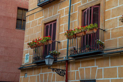 Beautiful balcony with flowers in the streets of Madrid, Spain.